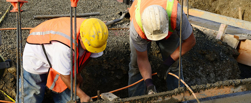 two men working on the base of the structure